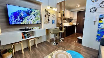 Design Condo, Balcony, Pool View | Living area | 50-inch Smart TV with digital channels, Netflix, streaming services