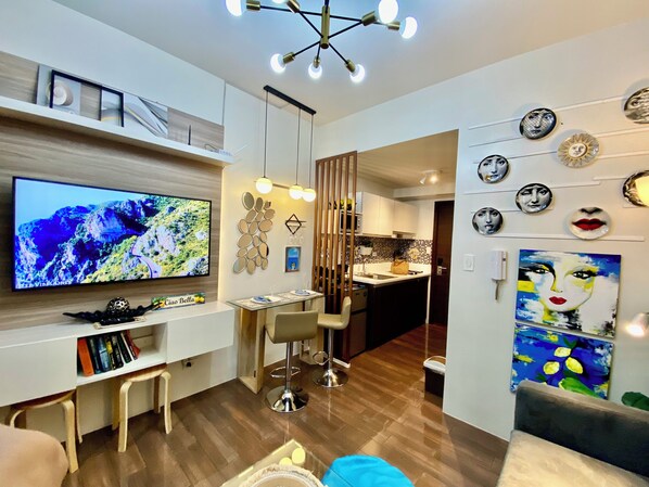 Design Condo, Balcony, Pool View | Living area | 50-inch Smart TV with digital channels, Netflix, streaming services - Smdc Air Residences (Makati)