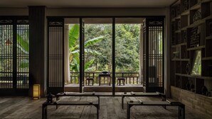 A traditional room with tatami mats, sliding doors, and a view of greenery. - Fanjingshan Ansu Homestay (Tongren)