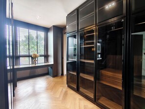 A modern room with a large window, wooden flooring, and a built-in wardrobe with glass doors. - The Haven Boutique Pool Villa Morn 2, Near Central Chiang Mai (San Klang - San Kamphaeng)