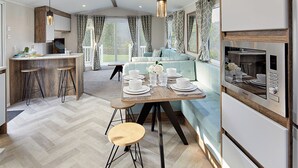 A modern kitchen with a dining area, a built-in oven, and a seating area with a view. - 2 bedroom accommodation in Bishop Auckland (Bishop Auckland)
