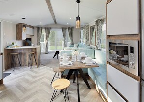 A modern kitchen with a dining area, a built-in oven, and a seating area with a view. - 1 bedroom accommodation in Bishop Auckland (Bishop Auckland)
