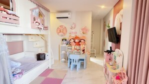 A child's bedroom with bunk beds, a desk, and a vanity with mirrors.