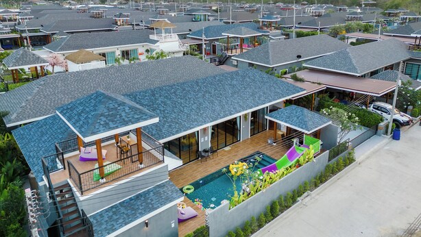 A residential area with multiple houses, each featuring a swimming pool and a wooden deck. - OC Breeze Casa Private Pool Villa With 3 Bedrooms, Near Cha-am Beach (Cha-am)