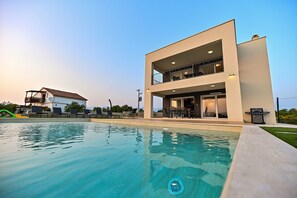 A modern two-story house with a pool, outdoor seating, and a barbecue area. - Villa Giovanni Zadar Villas (Razanac)
