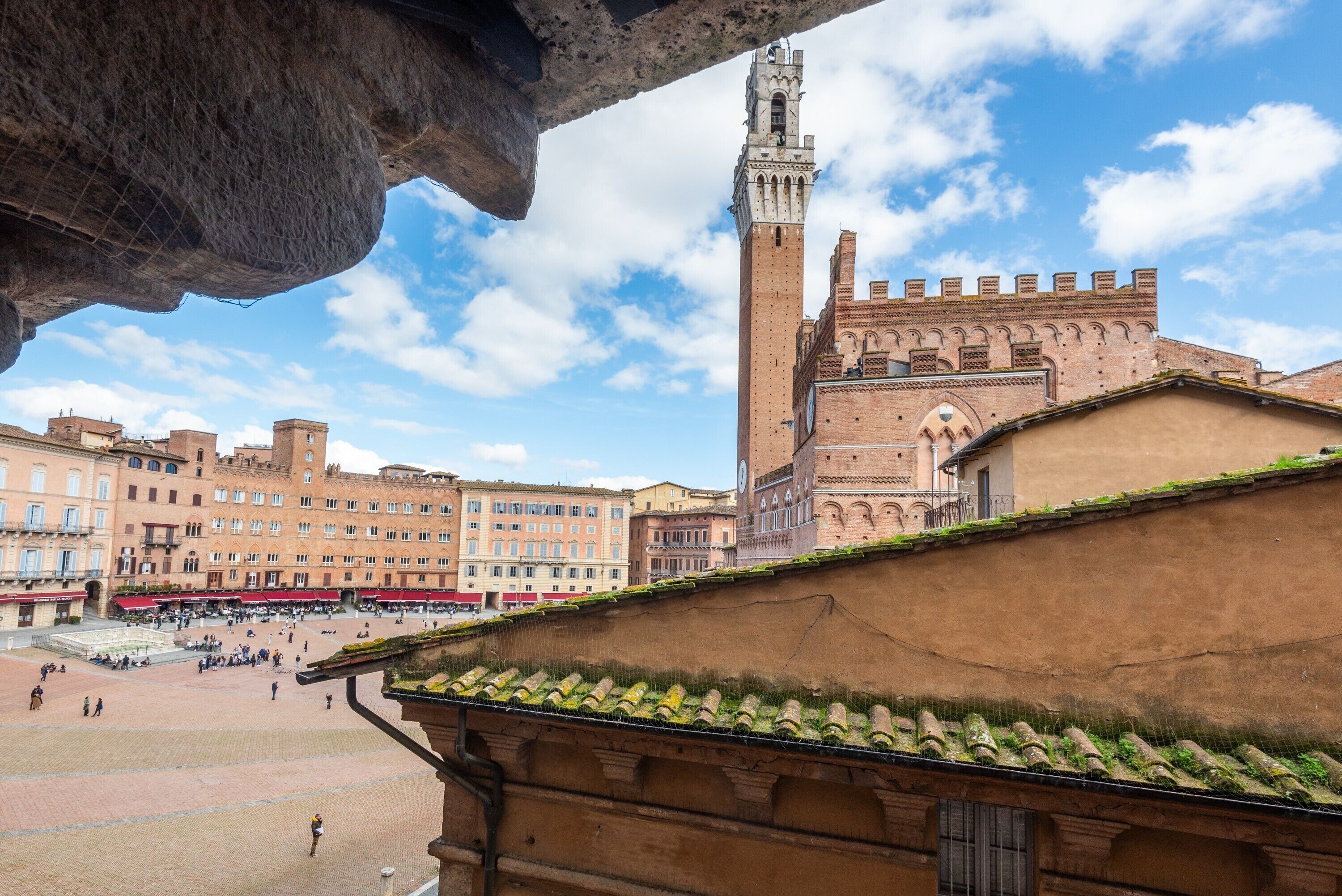 A historic square with a prominent tower and a large open space.