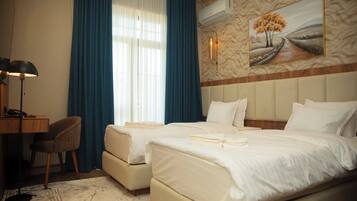 Deluxe Room, Balcony, City View | In-room safe, desk, laptop workspace, blackout curtains