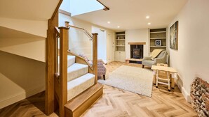A staircase with a wooden handrail leading to a landing. - Host & Stay | The Coral Cottage (Morley Saint Botolph)