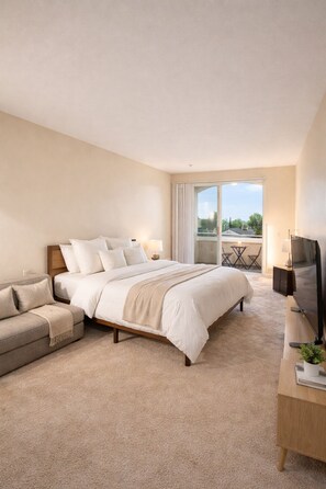 A hotel room with a large bed, a sofa, a TV, and a balcony with a view. - 1BR Marina Del Rey Escape (Marina del Rey)