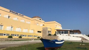 Ein Gebäude mit gelber Fassade und einem Boot davor.
