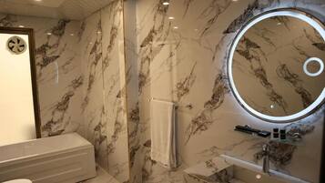 Separate tub and shower, towels, soap, shampoo