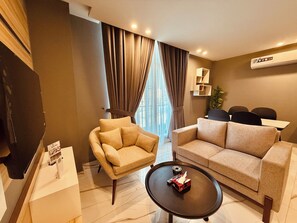 Deluxe Apartment, City View | Living area | 55-inch Smart TV with digital channels, Netflix, Hulu - The Holton Stays by Bayti (Islamabad)