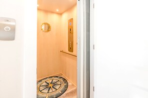 A hotel elevator with a control panel and a compass floor design. - Bitchin' Beach House - Killer Views from this 4 BR Home; Great Yard; Elevator; (N. Topsail Beach)