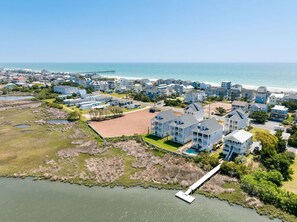 A coastal residential area with houses, a beach, and a pier. - Twin Shores - 6 BR, Heated Pool, Great Sound Views, Built in 2025 (Surf City)