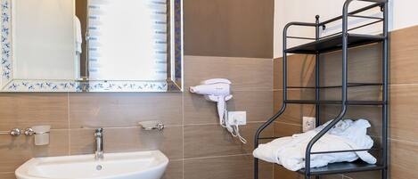 A bathroom with a sink, mirror, towel rack, and a hairdryer.