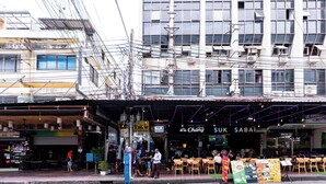 A street scene with a row of shops, including a tailor and a massage parlor. - The Hidden Khaosan (Bangkok)