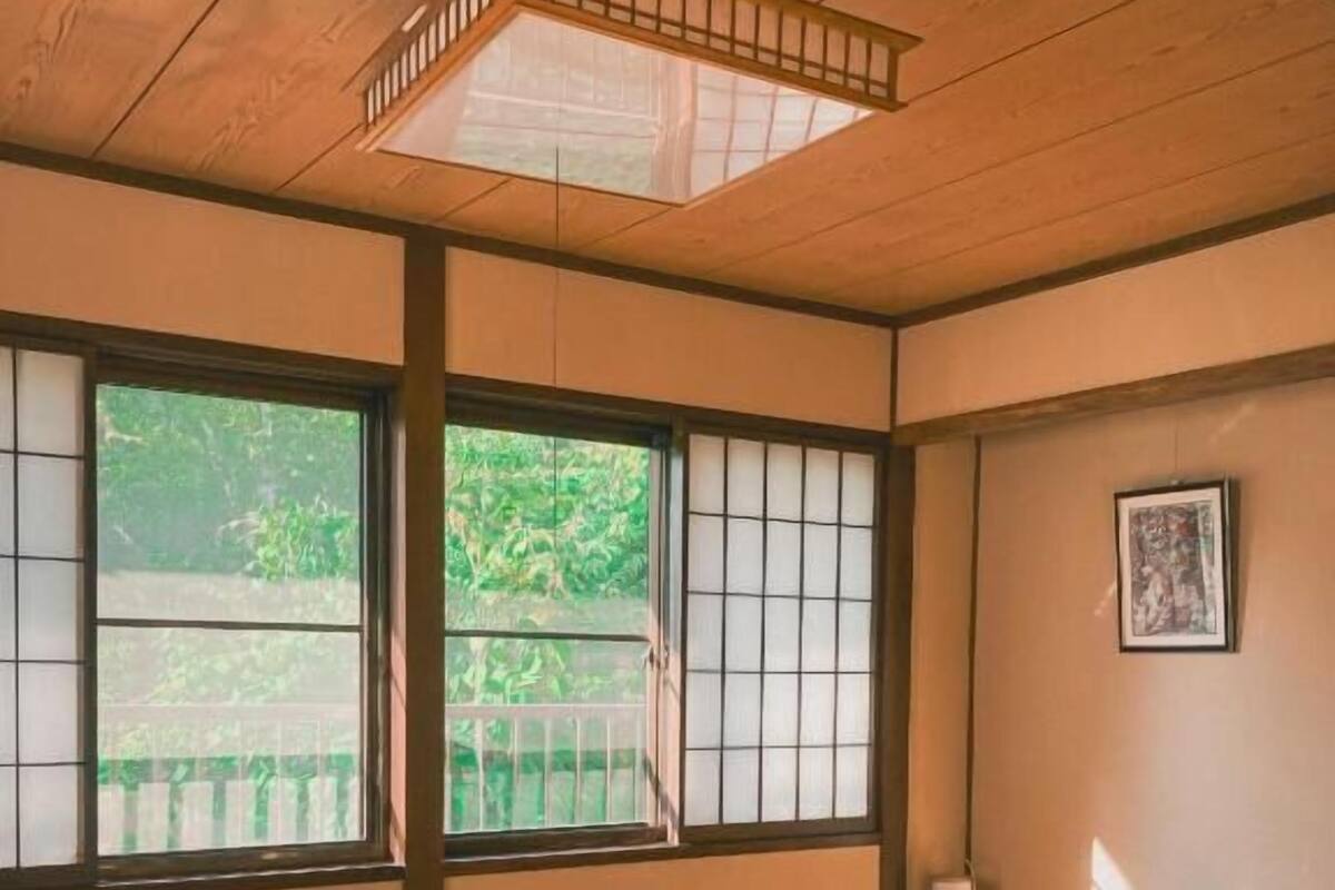 A traditional Japanese room with tatami flooring, a wooden table, and shoji screens.