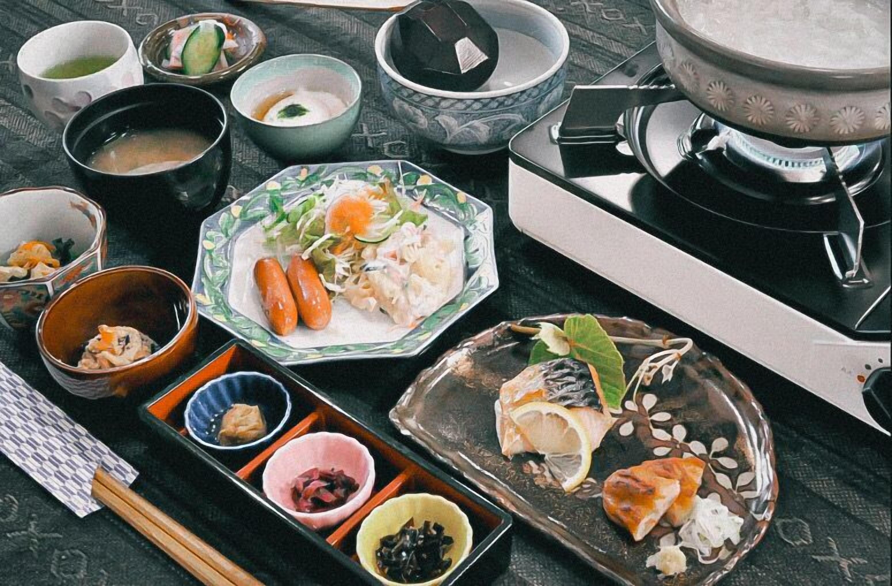 A traditional Japanese meal setup with various dishes and bowls on a table.