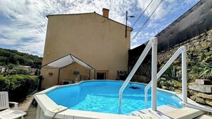 A swimming pool with a white deck and a white canopy. - Gîte La Bastide Saint-Roc Haute Vallée de l'Aude (Antugnac)