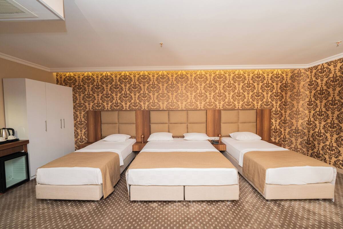 Executive Quadruple Room | In-room safe, iron/ironing board, free WiFi