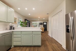 A modern kitchen with a central island, built-in appliances, and a view to the living area. - < 1 Mi to Georgetown Square: Pet-friendly Getaway! (Georgetown)