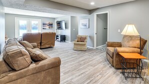 A spacious living room with a sectional sofa, a recliner, and a coffee table. - Waterfront Deck, Shell Knob Gem on Table Rock! (Shell Knob)