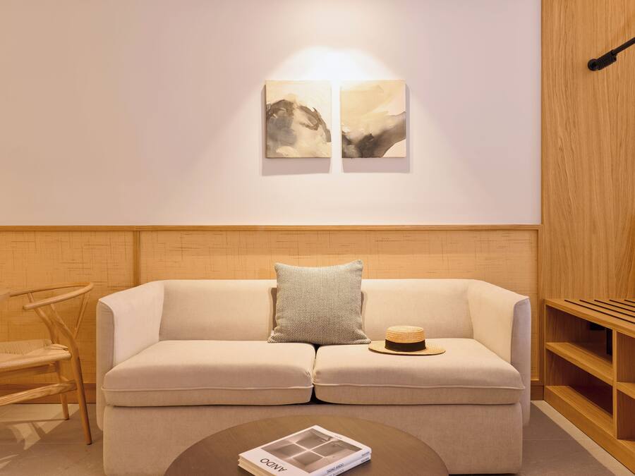 A modern living room with a sofa, a coffee table, and a bookshelf.