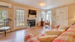 A cozy living room with a fireplace, comfortable seating, and large windows. - Hike, Swim & Fish On-site: Blue Ridge Mtn Getaway (Thurmond)