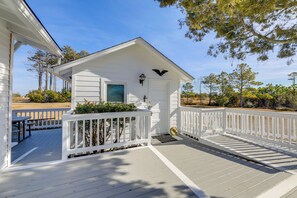 A white wooden porch with a white railing, a small window, and a bird-shaped light fixture. - Relax Fireside: Retreat 1 Mi to Davis Ferry (Davis)