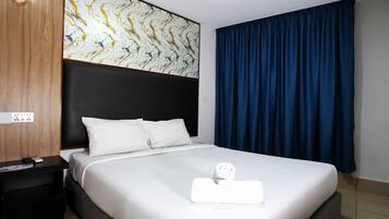 A hotel room with a bed, a nightstand, a wall with a marble-like pattern, and a large window with blue curtains.