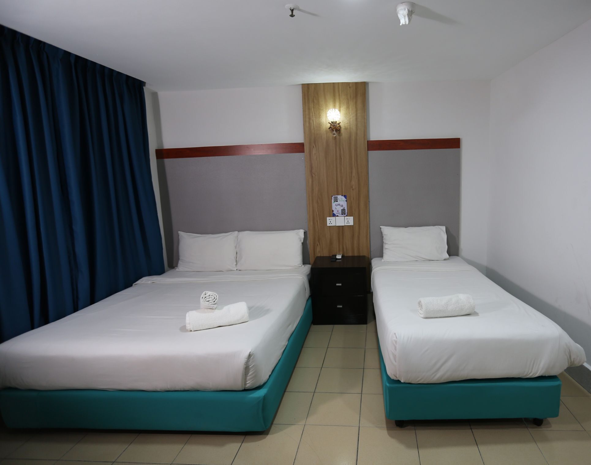 Deluxe Triple Room, Non Smoking, Private Bathroom | Desk, laptop workspace, blackout drapes, iron/ironing board