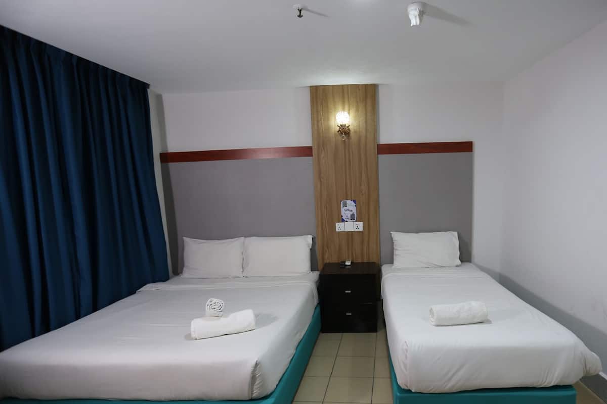 Deluxe Triple Room, Non Smoking, Private Bathroom | Desk, laptop workspace, blackout drapes, iron/ironing board