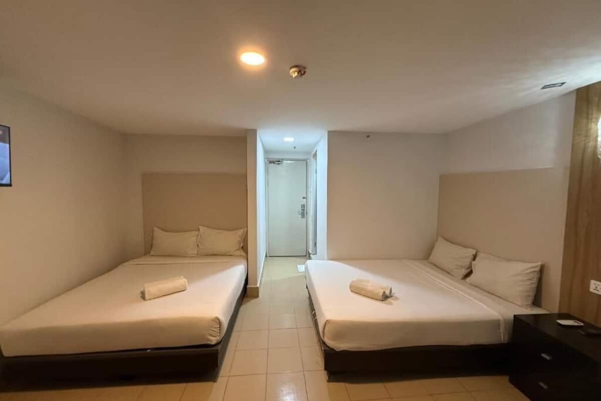 Deluxe Quadruple Room, 2 Queen Beds, Non Smoking, Private Bathroom | Desk, laptop workspace, blackout drapes, iron/ironing board