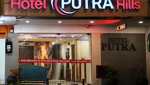 The exterior of Hotel PUTRA Hills with a prominent entrance and a sign indicating it is open. - Hotel Putra Hills at WTCKL (Kuala Lumpur)