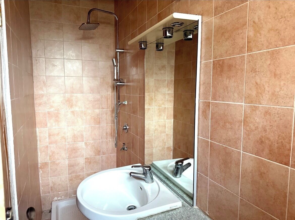 A bathroom with a bathtub, a sink, and a shower.