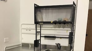 A compact kitchenette with a sink, a small countertop, and a storage area. - Studio Apartament 1st Floor Piedrapintada Coffee Wifi TV (Ibagué)