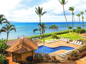 A resort with a swimming pool, lounge chairs, and palm trees. - Where Ocean Meets Sky Maalaea Refreshed Oceanfront Condo Panoramic Views (Wailuku)