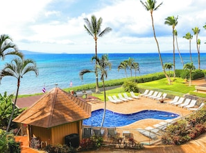 A resort with a swimming pool, lounge chairs, and palm trees. - Where Ocean Meets Sky Maalaea Refreshed Oceanfront Condo Panoramic Views (Wailuku)