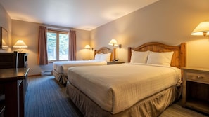 A hotel room with two beds, a desk, and a window with curtains. - Cahilty #241/243 1 Bedroom Hotel Room (Sun Peaks)