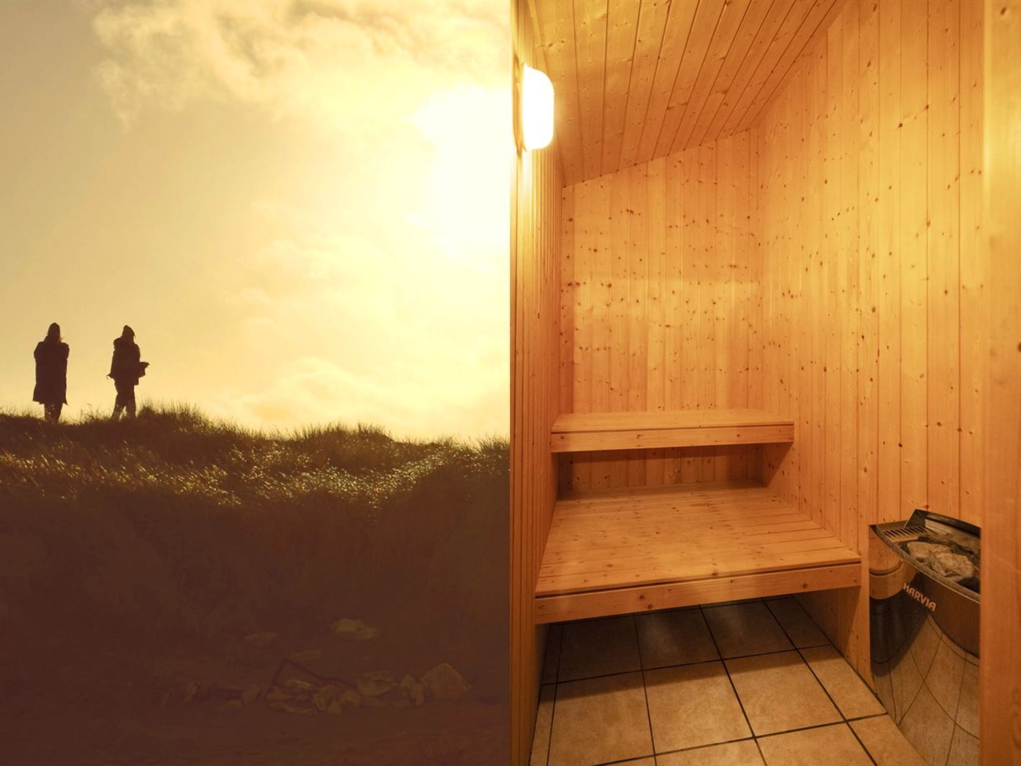 A sauna with a wooden interior and a view of a sunset with two people silhouetted against the sky.