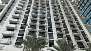 A tall, modern building with multiple balconies and a sign reading "The Crosby" at the base. - Sophisticated 2BR/2BA at Miami World Center (Miami)
