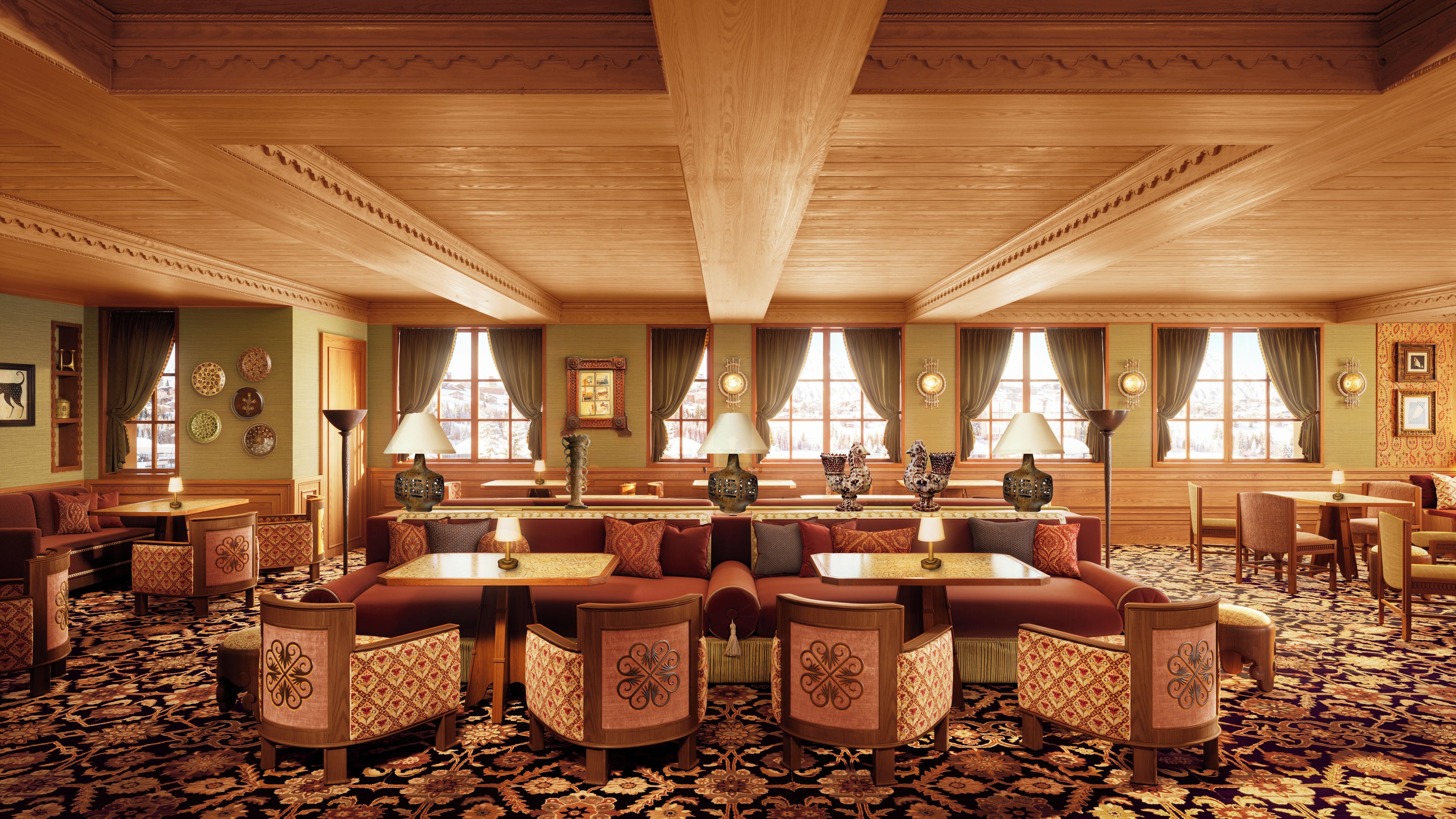 A spacious hotel lobby with a central seating area, multiple windows, and a patterned carpet.