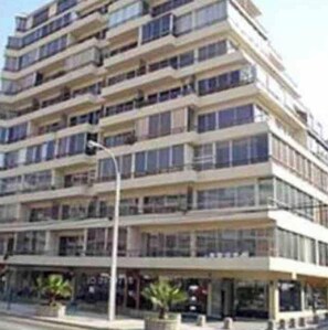 A multi-story hotel with balconies, large windows, and a flat facade. - Exclusive Ocean-view Apartment With Terrace & Parking Long Stays Marchdecembe (Vina del Mar)