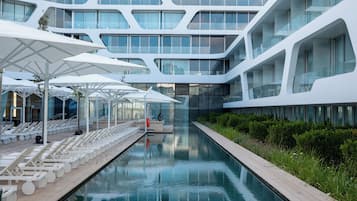 Seasonal outdoor pool, open 9:00 AM to 6:00 PM, pool umbrellas