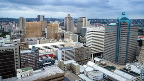 A cityscape with various buildings, including a prominent blue-domed structure and several high-rise buildings. - Spacious 6-bedroom apartment with AC in peaceful Detroit (Detroit)