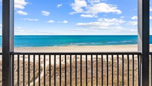 A beach view through a window with a metal railing. - Pet Friendly Beach House - Seminole Wind (Port St. Joe)
