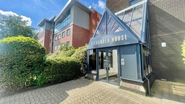 A modern building with the sign "Alexander House" indicating a hotel or residential complex. - 2-Bed | Old Trafford | Free Parking | Contractors (Stretford)