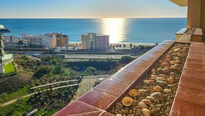 A balcony with a view of the sea and buildings. - Two Bedroom Apartment to rent in Carvajal (Fuengirola)