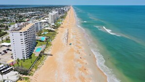 A coastal hotel with multiple floors, a pool, and a beach view. - New listing! 3-bedroom. Ocean-Front, Corner Unit with Panoramic Views (Ormond Beach)