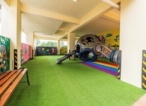 A play area with artificial grass, a slide, and colorful murals on the walls. - Nested in the Heart of Nairobi, Modern furnished with a safe for your valuables. (Nairobi)